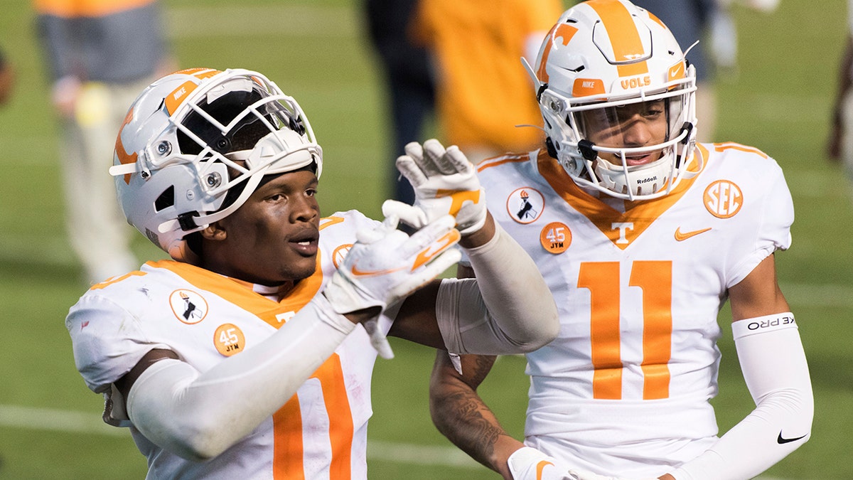 Tennessee defensive back Bryce Thompson (0) and Henry To'o To'o (11) celebrate the team's 31-27 win over South Carolina in an NCAA college football game Saturday, Sept. 26, 2020, in Columbia, S.C. (AP Photo/Sean Rayford)