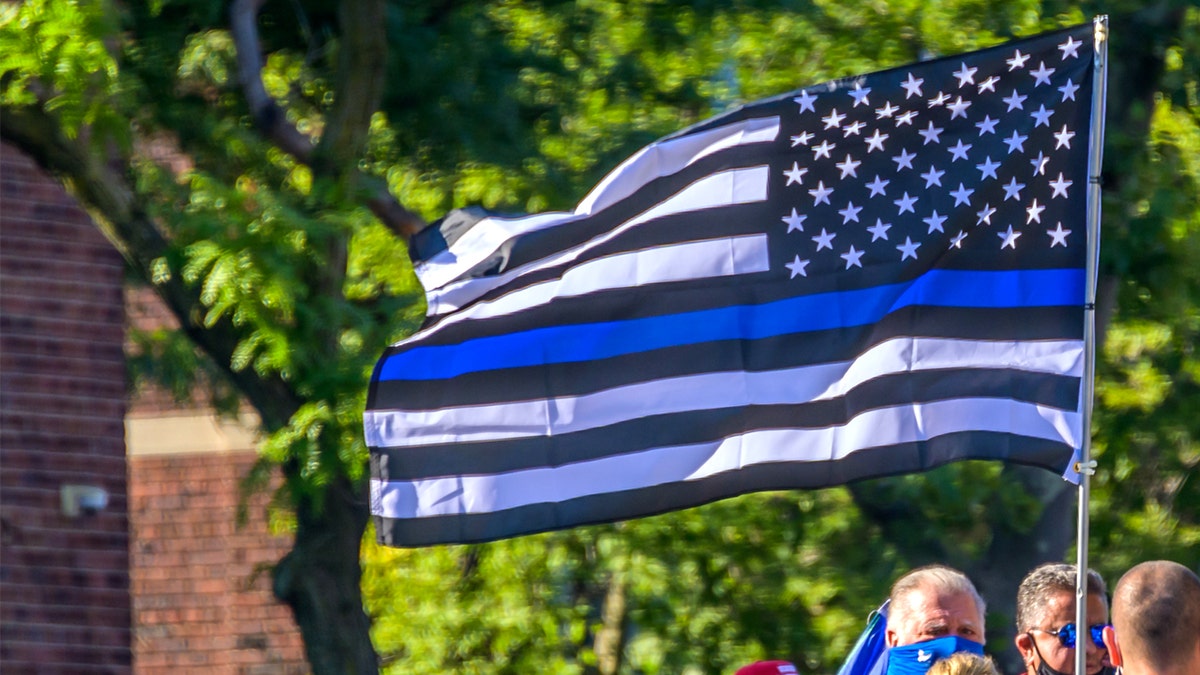 Pro-cop protesters carrying a Blue Lives Matter flag at the protest. 