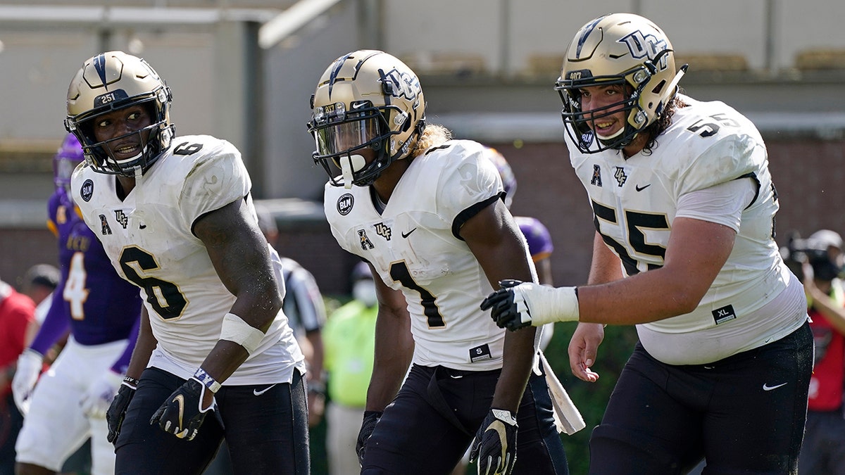 Central Florida wide receiver Marlon Williams (6), wide receiver Jaylon Robinson (1) and offensive lineman Matthew Lee (55) react following Robinson's touchdown against East Carolina during the second half of an NCAA college football game in Greenville, N.C., Saturday, Sept. 26, 2020. (AP Photo/Gerry Broome)