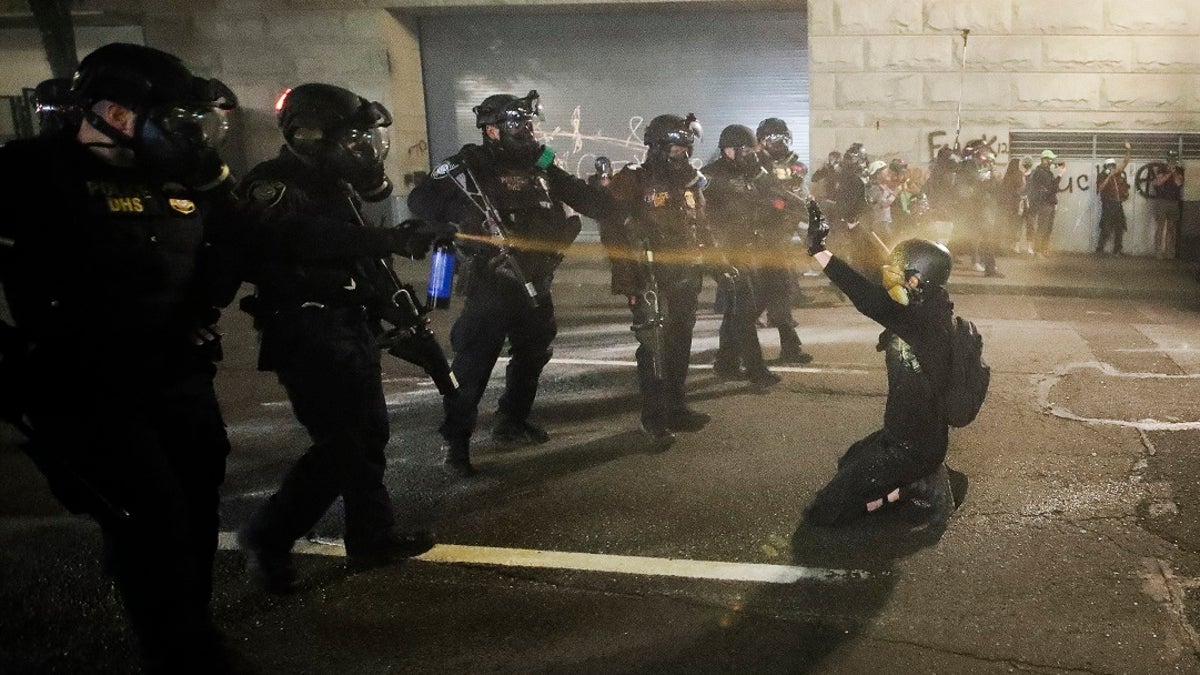 In this July 29, 2020, file photo, a demonstrator is pepper-sprayed shortly before being arrested during a Black Lives Matter protest at the Mark O. Hatfield United States Courthouse in Portland, Ore. (AP Photo/Marcio Jose Sanchez, File)