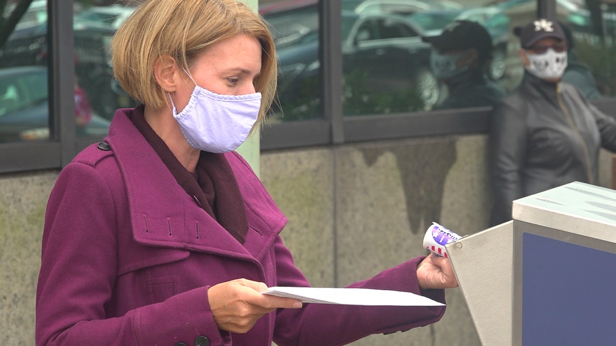 Amy Kennedy drops off her mail-in ballot in Atlantic City, N.J.