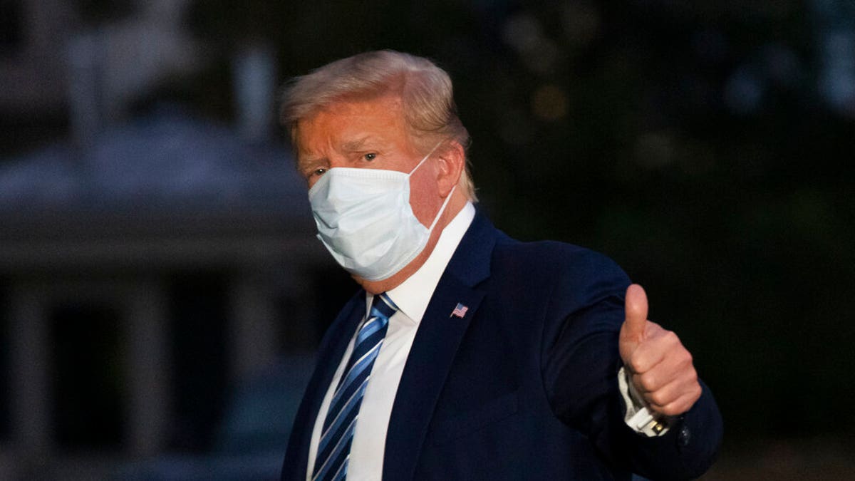 President Donald Trump gives thumbs up as he returns to the White House Monday, Oct. 5, 2020, in Washington, after leaving Walter Reed National Military Medical Center, in Bethesda, Md. Trump announced he tested positive for COVID-19 on Oct. 2. (AP Photo/Alex Brandon)