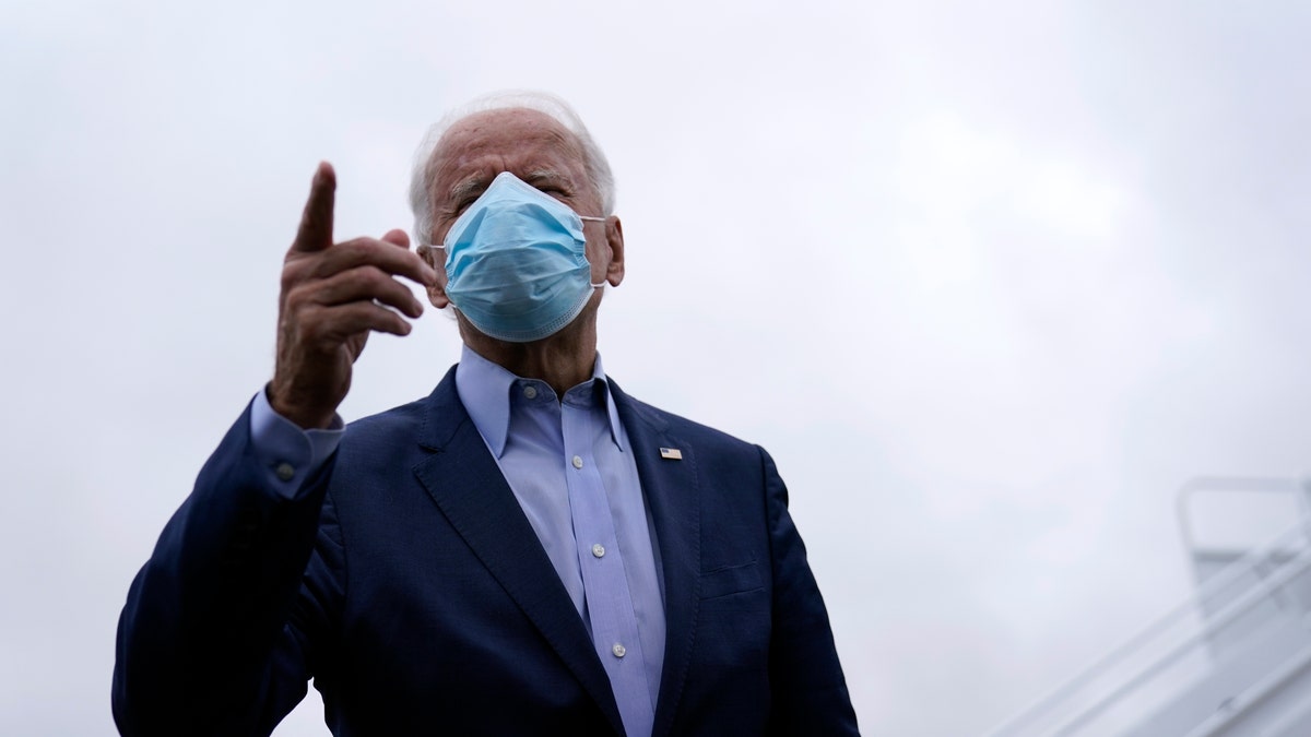 Democratic presidential candidate former Vice President Joe Biden speaks to members of the media before boarding his campaign plane at New Castle Airport, in New Castle, Del., Monday, Oct. 12, 2020, en route to Ohio. (AP Photo/Carolyn Kaster)