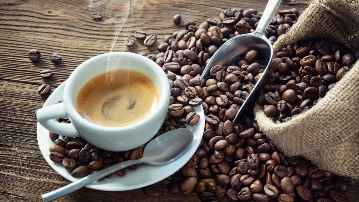 Cup of espresso with coffee beans