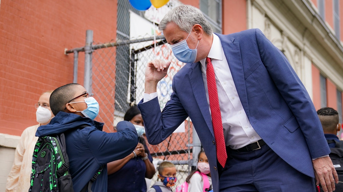 New York Mayor Bill de Blasio greets students as they arrive for in-person classes Tuesday in the Manhattan borough of New York City. (AP)