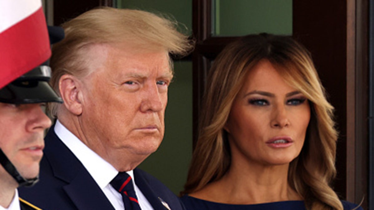 Donald and Melania Trump standing together