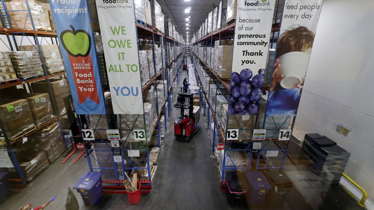 Pallets of various foods are stacked on shelves in the extensive warehouse at the Houston Food Bank Wednesday, Oct. 14, 2020, in Houston. It's the largest U.S. food bank and national food bank leaders say they don't see an end in sight to the demand. (AP Photo/Michael Wyke)