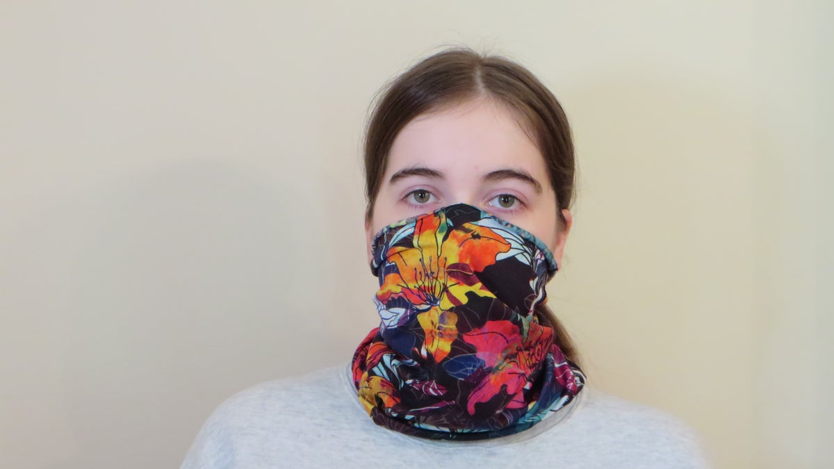 Emma Fischer, study co-author and student at Duke University, dons a neck gaiter. Study co-author Warren S. Warren says this neck gaiter is slightly stretchy and opaque when worn, but single layer and thin enough to see a light through it. 