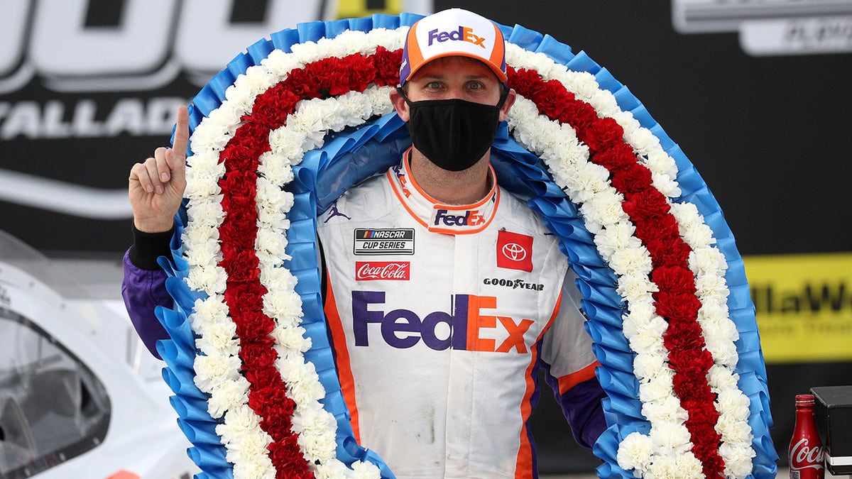 TALLADEGA, ALABAMA - OCTOBER 04: Denny Hamlin, driver of the #11 FedEx Express Toyota, celebrates in Victory Lane after winning the NASCAR Cup Series YellaWood 500 at Talladega Superspeedway on October 04, 2020 in Talladega, Alabama. (Photo by Chris Graythen/Getty Images)