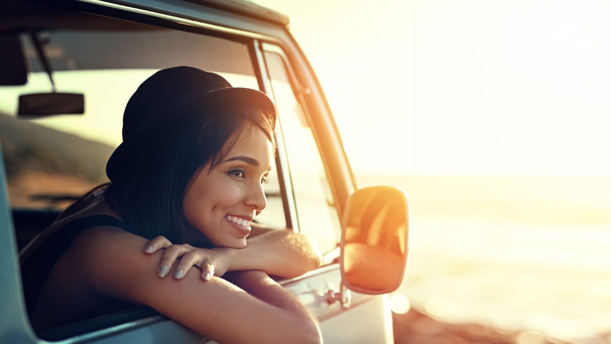 Shot of a young woman enjoying a relaxing road trip. (iStock).?