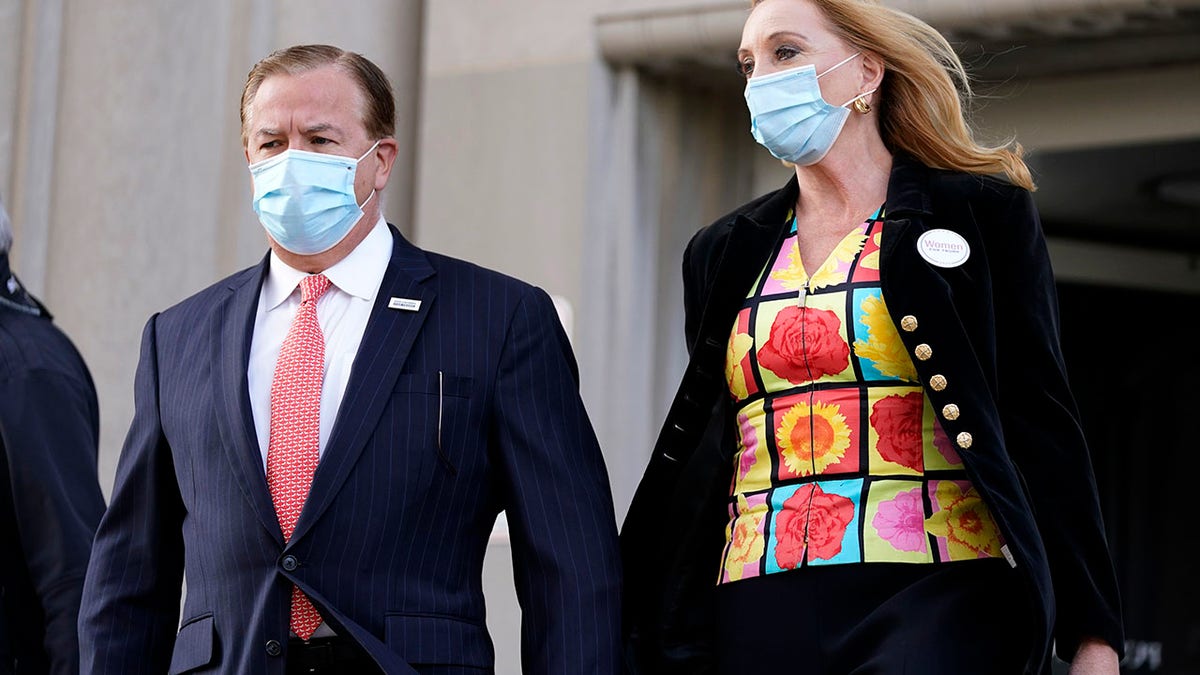Mark and Patricia McCloskey leave following a court hearing Wednesday in St. Louis. The McCloskeys have pleaded not guilty to two felony charges, unlawful use of a weapon and tampering with evidence, after they were seen waving guns at protesters marching on their private street this past summer. (AP Photo/Jeff Roberson)
