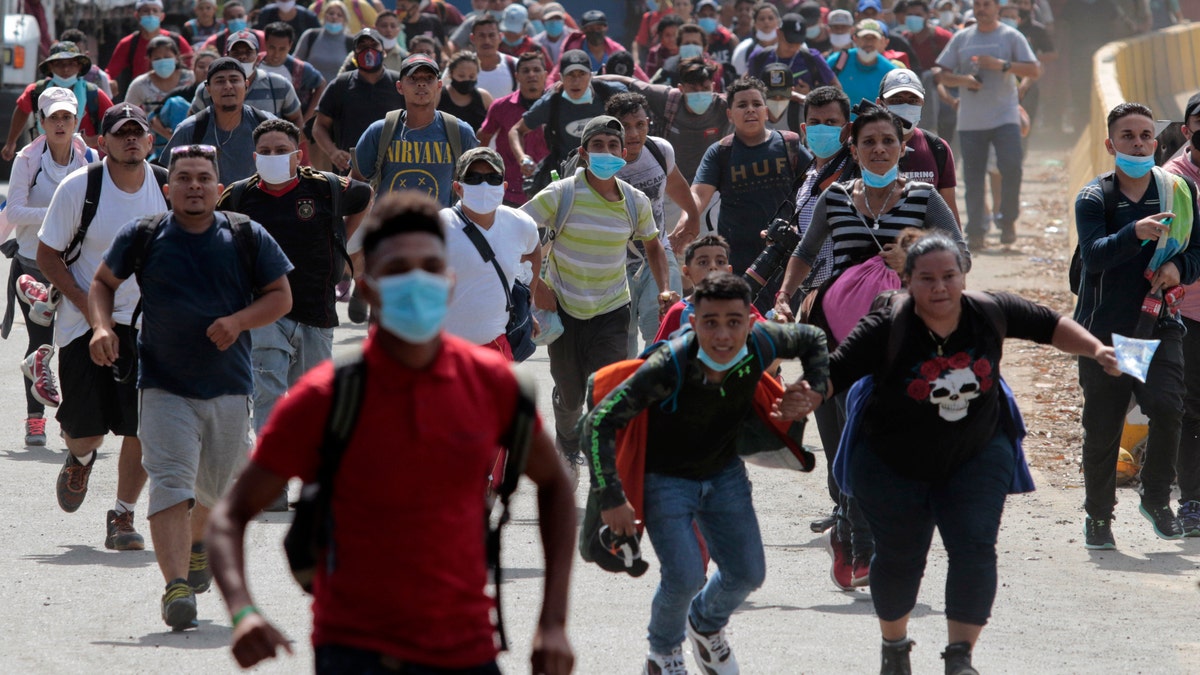 Migrants cross the border from Corinto, Honduras, into Corinto, Guatemala, on Thursday. (AP)