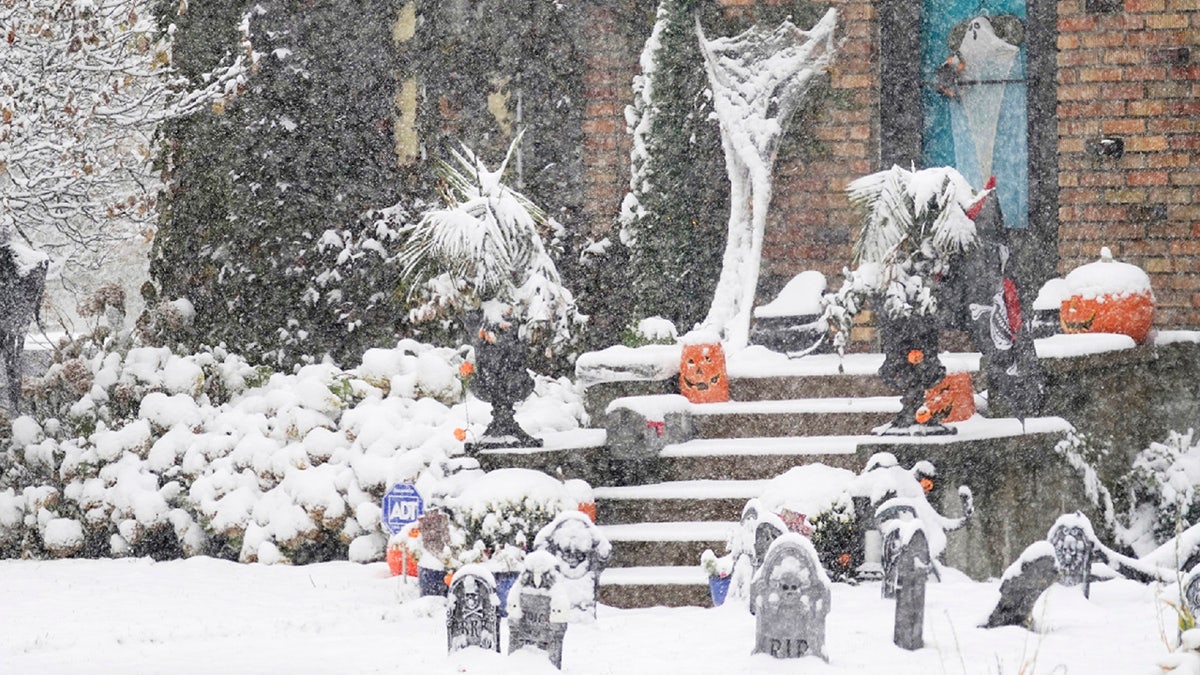 A Halloween display in Minneapolis receives the first measurable snow of the season as a storm arrived over much of Minnesota Tuesday, Oct. 20, 2020.