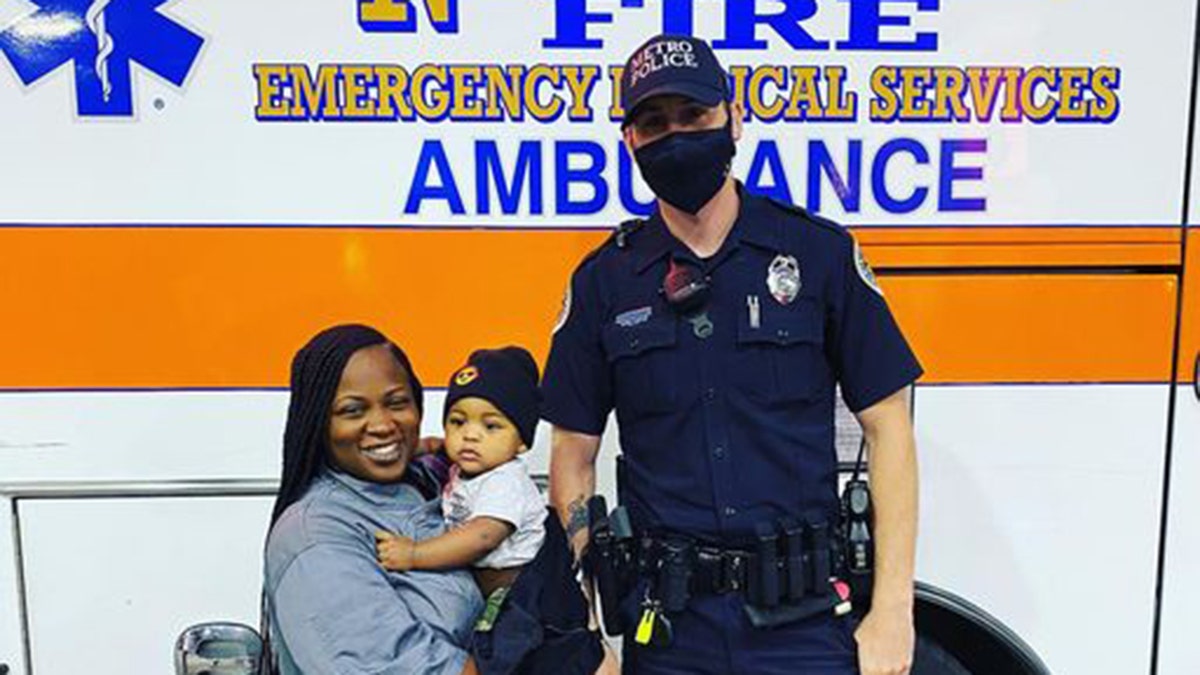 Metro Nashville Police Officer Philip Claibourne poses for a photo with Tanisha Rutledge, 29, and her 9-month-old baby boy.