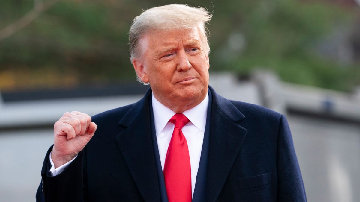 President Donald Trump pumps his fist as he arrives to speak at a campaign rally at Keith House, Washington's Headquarters, Oct. 31, in Newtown, Pa. (Associated Press)