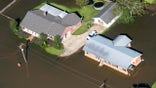 Houses surrounded by flood waters are seen in the aftermath of Hurricane Delta Saturday Oct. 10, 2020, in Welsh, La. (Bill Feig/The Advocate via AP, Pool)