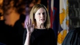 President Donald Trump watches as Supreme Court Justice Clarence Thomas administers the Constitutional Oath to Amy Coney Barrett on the South Lawn of the White House in Washington, Monday, Oct. 26, 2020, after Barrett was confirmed by the Senate earlier in the evening. (AP Photo/Patrick Semansky)