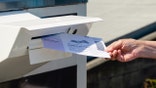 Everett, WA - USA / 07/30/2020:  Dropping Mail in Ballot into mail box