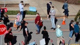 Voters wait in line outside the Herbert C. Young Community Center in Cary, N.C. on the first day of early voting Thursday, Oct. 15, 2020. (Ethan Hyman/The News &amp; Observer via AP)
