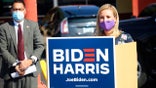 Phoenix Mayor Kate Gallego, right, speaks at a news conference in front of an early voting site in the Phoenix neighborhood of Maryvale where she backed Democrat Joe Biden for president and urged voters to vote early as Maricopa County Supervisor Steve Gallardo, left, listens Wednesday, Oct. 7, 2020.