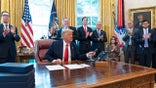President Donald Trump hangs up a phone call with the leaders of Sudan and Israel, as Treasury Secretary Steven Mnuchin, left, Secretary of State Mike Pompeo, White House senior adviser Jared Kushner, National Security Adviser Robert O'Brien, and others applaud in the Oval Office of the White House, Friday, Oct. 23, 2020, in Washington. (AP Photo/Alex Brandon)
