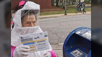 Retired Chicago teacher, 102, dons hazmat suit to vote by mail