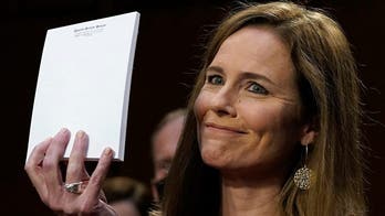 Amy Coney Barrett answers questions at confirmation hearing without notes, holds up blank notepad