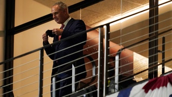 AP Interview: Manfred likes larger playoff, runner in extras