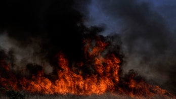 California wildfire forces evacuations of 60,000 in Orange County as gusty winds blast region