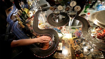 Prague cafe employees set up slot car races throughout bar emptied by COVID-19
