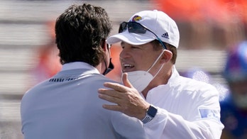 Kansas coach cleared of virus but skips West Virginia game