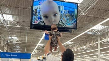 Dad, baby go viral after they pose for Walmart security camera close-up