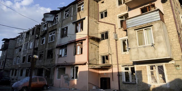 A view of a residential area and cars that were allegedly damaged by shelling during a military conflict in self-proclaimed Republic of Nagorno-Karabakh, Stepanakert, Azerbaijan, Saturday, Oct. 3, 2020. The fighting is the biggest escalation in years in the decades-long dispute over the region, which lies within Azerbaijan but is controlled by local ethnic Armenian forces backed by Armenia. (David Ghahramanyan/NKR InfoCenter PAN Photo via AP)