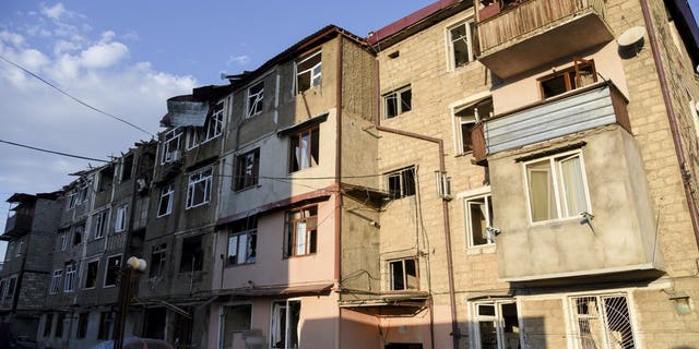 A view of a residential area and cars that were allegedly damaged by shelling during a military conflict in self-proclaimed Republic of Nagorno-Karabakh, Stepanakert, Azerbaijan, Saturday, Oct. 3, 2020. The fighting is the biggest escalation in years in the decades-long dispute over the region, which lies within Azerbaijan but is controlled by local ethnic Armenian forces backed by Armenia. (David Ghahramanyan/NKR InfoCenter PAN Photo via AP)