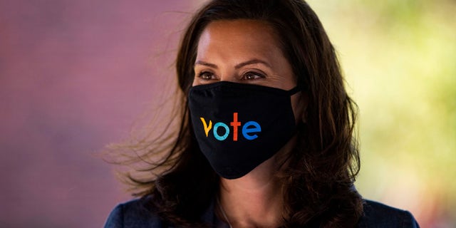 Michigan Governor Gretchen Whitmer wears a mask with the word "vote" displayed on the front during a healthcare roundtable, Wednesday, October 7, 2020, in Kalamazoo, Mich. (Nicole Hester / Ann Arbor News via AP) /