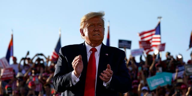 President Donald Trump applauds after a campaign rally at Tucson International Airport, Monday, Oct. 19, 2020, in Tucson, Ariz. (AP Photo/Alex Brandon)