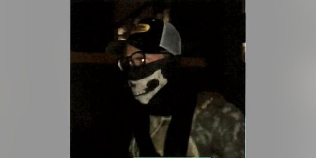 A man wearing a face covering was identified as Ivan Hunter, who is suspected of firing into a Minneapolis police precinct.