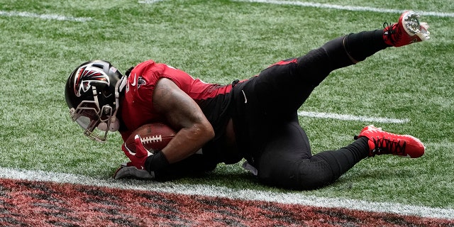 Atlanta Falcons running back Todd Gurley (21) scores a touchdown against the Detroit Lions during the second half of an NFL football game, Sunday, Oct. 25, 2020, in Atlanta. (AP Photo/John Bazemore)