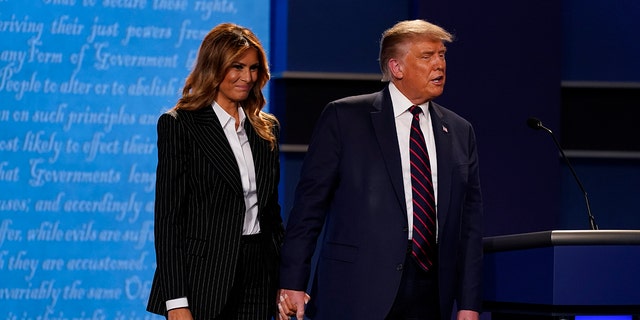 President Trump and first lady Melania Trump tested positive for the coronavirus Thursday night and are quarantining at the White House. Fox News' Chris Wallace noticed Melania Trump didn't wear a mask on stage at the end of the first presidential debate Tuesday, Sept. 29, 2020, in Cleveland, Ohio. (AP Photo/Patrick Semansky)
