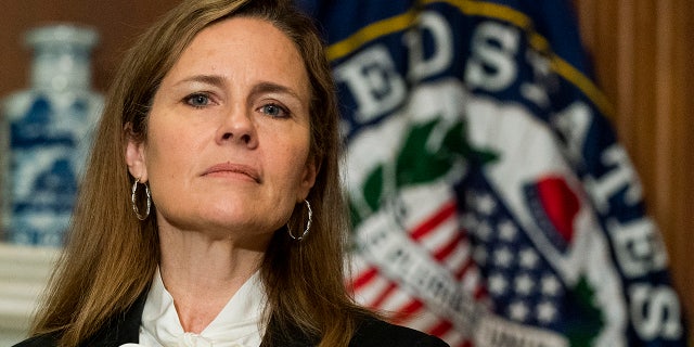 Supreme Court nominee Judge Amy Coney Barrett listens as Sen. Jerry Moran, R-Ks., not shown, speaks during their meeting on Capitol Hill, Thursday, Oct. 1, 2020, in Washington. (AP Photo/Manuel Balce Ceneta, POOL)