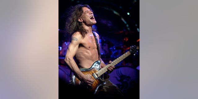 FILE - In this Aug. 5, 2004 file photo, Van Halen guitarist Eddie Van Halen performs in Phoenix. (AP Photo/Tom Hood, File)