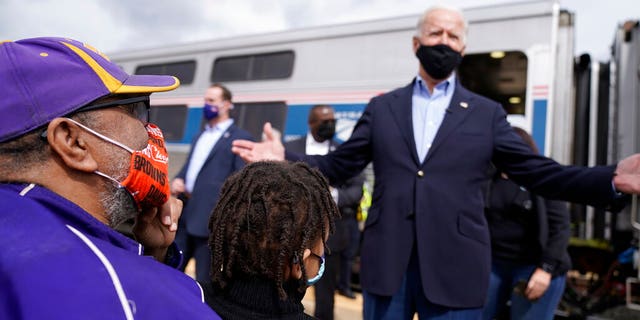 Supporters greet Democratic presidential candidate former Vice President Joe Biden as he steps of the train at Amtrak's Alliance Train Station, Wednesday, Sept. 30, 2020, in Alliance, Ohio. Biden is on a train tour through Ohio and Pennsylvania today. (AP Photo/Andrew Harnik)