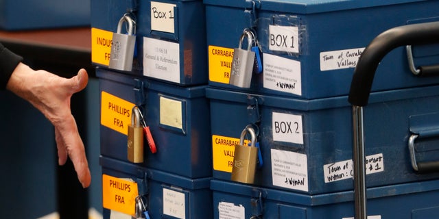 FILE - In this Nov. 12, 2018 file photo, ballot boxes are brought into for a ranked choice voting tabulation in Augusta, Maine. The state's supreme court is hearing more arguments from the Maine GOP, which is seeking to appeal to the U.S. Supreme Court to prevent ranked choice voting from being used in the presidential contest. (AOP Photo/Robert F. Bukaty, File)
