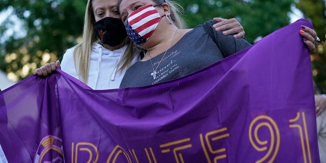 Sarah Lamers, left, comforts Jill Winters during a ceremony Thursday on the anniversary of the mass shooting three years earlier in Las Vegas. The ceremony was held for survivors and victim's families of the deadliest mass shooting in modern U.S. history. Officials updated the death toll from 58 to 60 after two women died within the last year from injures sustained during the shooting. (AP Photo/John Locher)