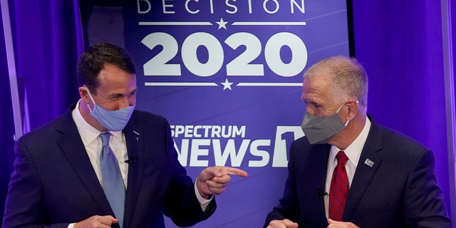 Democratic challenger Cal Cunningham, left, and U.S. Sen. Thom Tillis, R-N.C. greet each other after a televised debate Thursday, Oct. 1, 2020 in Raleigh, N.C. (AP Photo/Gerry Broome, Pool)