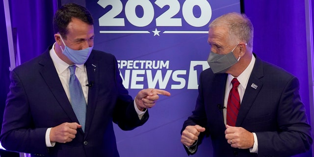 Democratic challenger Cal Cunningham, left, and U.S. Sen. Thom Tillis, R-N.C. greet each other after a televised debate Thursday, Oct. 1, 2020 in Raleigh, N.C. (AP Photo/Gerry Broome, Pool)