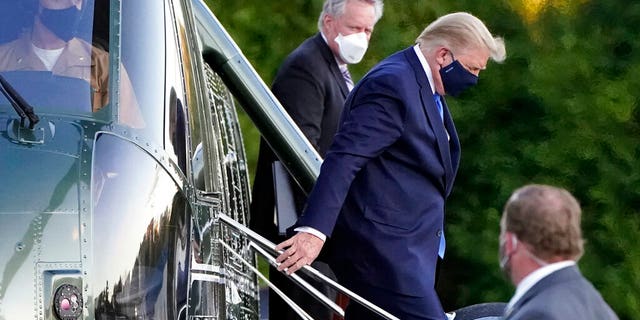 President Donald Trump arrives at Walter Reed National Military Medical Center, in Bethesda, Md., Friday, Oct. 2, 2020, on Marine One helicopter after he tested positive for COVID-19. White House chief of staff Mark Meadows is at second from left. (AP Photo/Jacquelyn Martin)