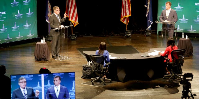 Sen. Mark Warner, left, D-Va., and his Republican challenger, Daniel Gade, right, go head to head over issues of racial inequalities during the U.S. Senatorial debate at Norfolk State University, Saturday, Oct. 3, 2020, in Norfolk, Va. (Associated Press)