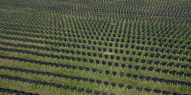 The empty chairs represent a fraction of the more than 200,000 lives lost due the COVID-19 are seen during the National COVID-19 Remembrance, at The Ellipse outside of the White House, Sunday, Oct. 4, 2020, in Washington. (AP Photo/Jose Luis Magana)