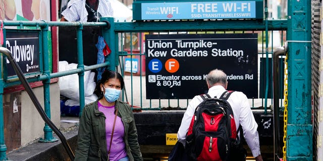 People navigate the stairs of the Kew Gardens subway station Monday, Oct. 5, 2020, in the Kew Gardens neighborhood of the Queens borough of New York.